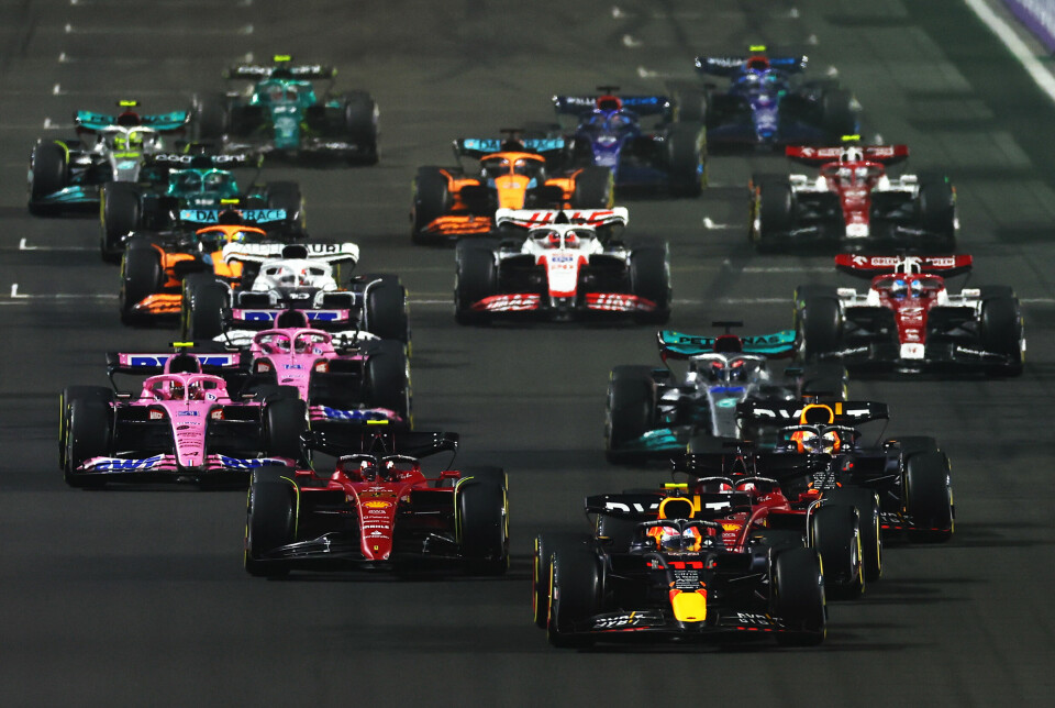 JEDDAH, SAUDI ARABIA - MARCH 27: Sergio Perez of Mexico driving the (11) Oracle Red Bull Racing RB18 leads Charles Leclerc of Monaco driving (16) the Ferrari F1-75 and the rest of the field into turn one at the start during the F1 Grand Prix of Saudi Arabia at the Jeddah Corniche Circuit on March 27, 2022 in Jeddah, Saudi Arabia. (Photo by Lars Baron/Getty Images) // Getty Images / Red Bull Content Pool // SI202203270395 // Usage for editorial use only //